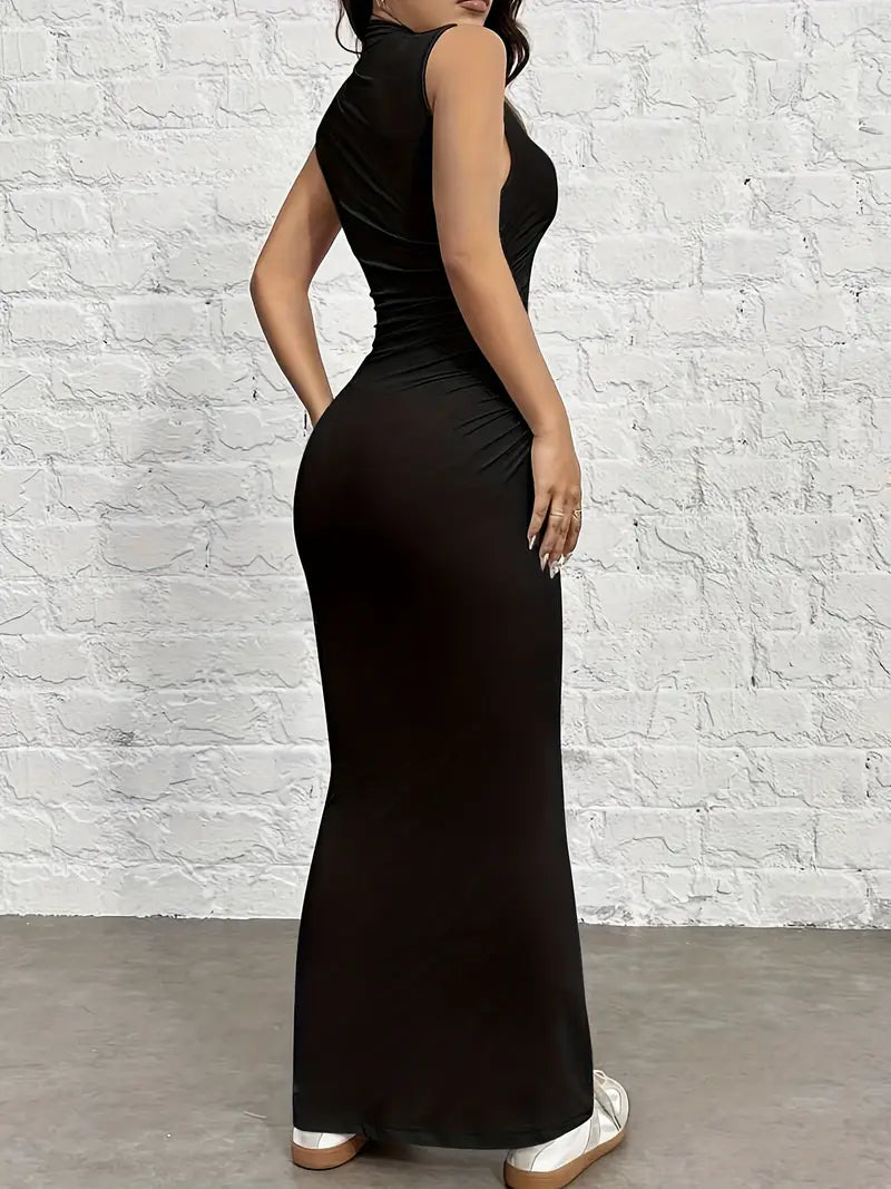 Woman wearing a black sleeveless dress against a white brick wall.
