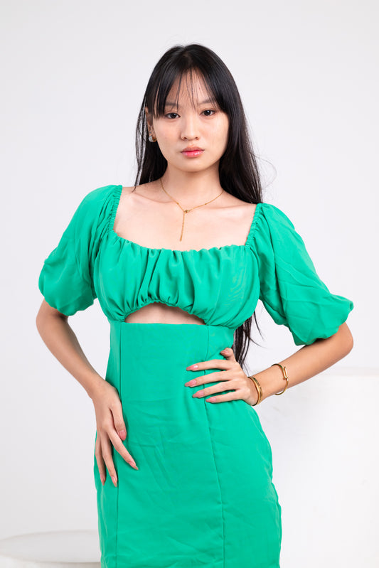 Woman wearing a green dress against a white background