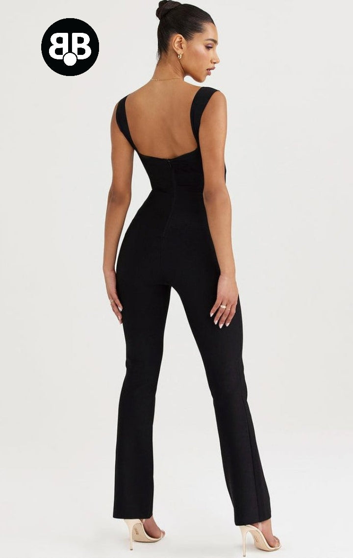 Woman wearing a black jumpsuit with a brand logo in the corner