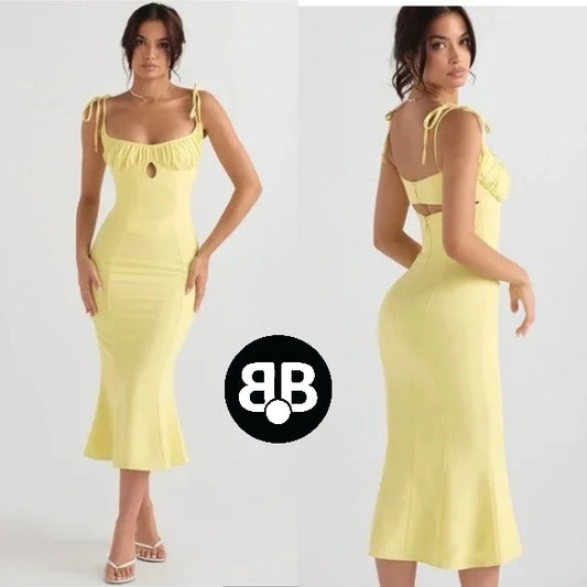 Yellow dress with cut-out design worn by a model on a white background, featuring the brand logo.