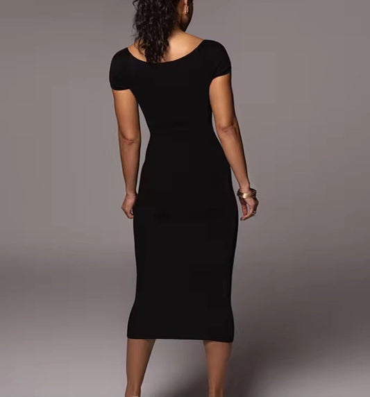 Woman wearing a black dress against a gray background