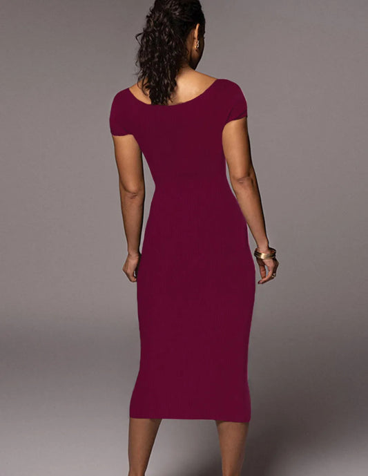 Woman wearing a burgundy dress against a gray background
