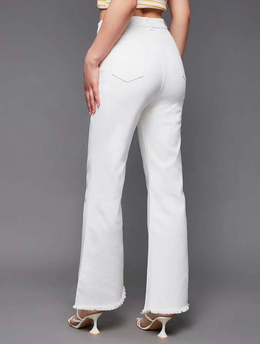 White flared jeans worn by a person on a gray background