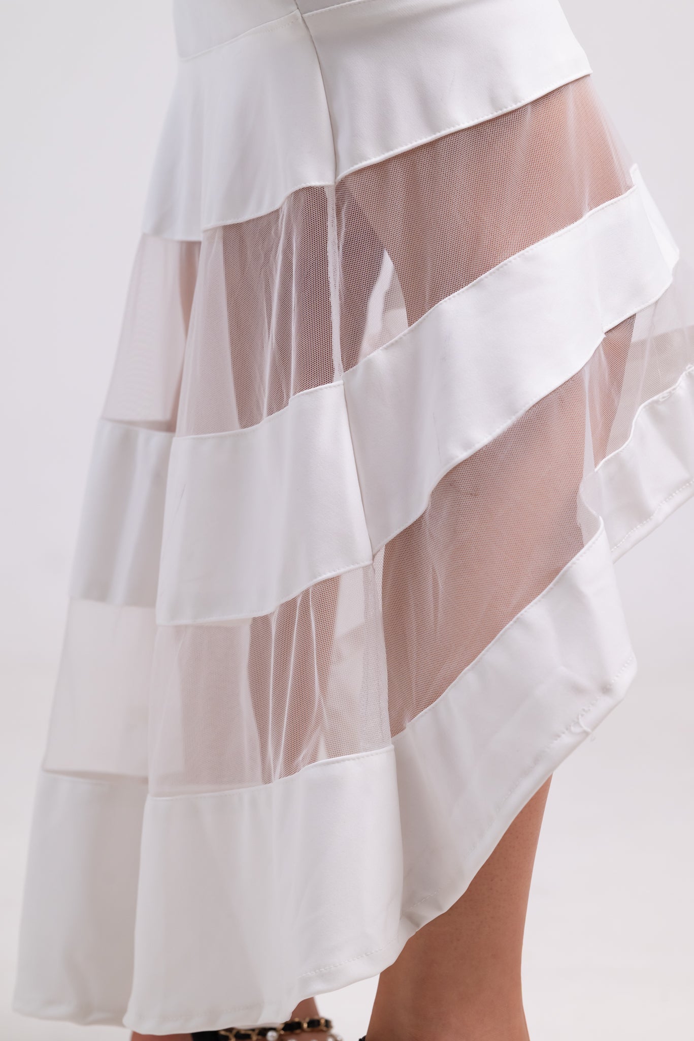 White skirt with sheer overlay on a white background