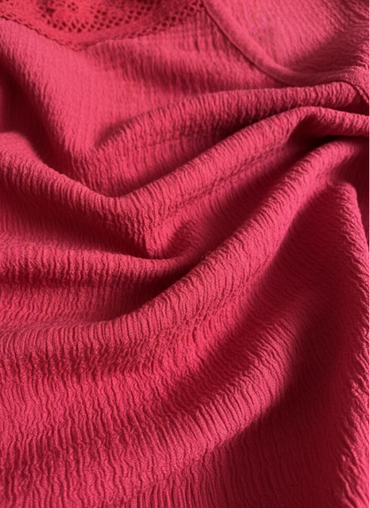 Close-up of red fabric with textured pattern