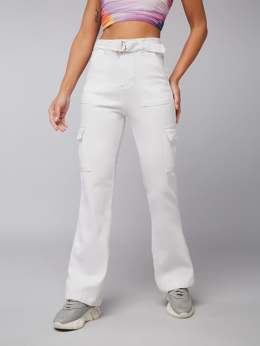 Person wearing white cargo pants on a gray background