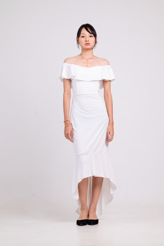 Woman wearing a white off-shoulder dress on a plain background
